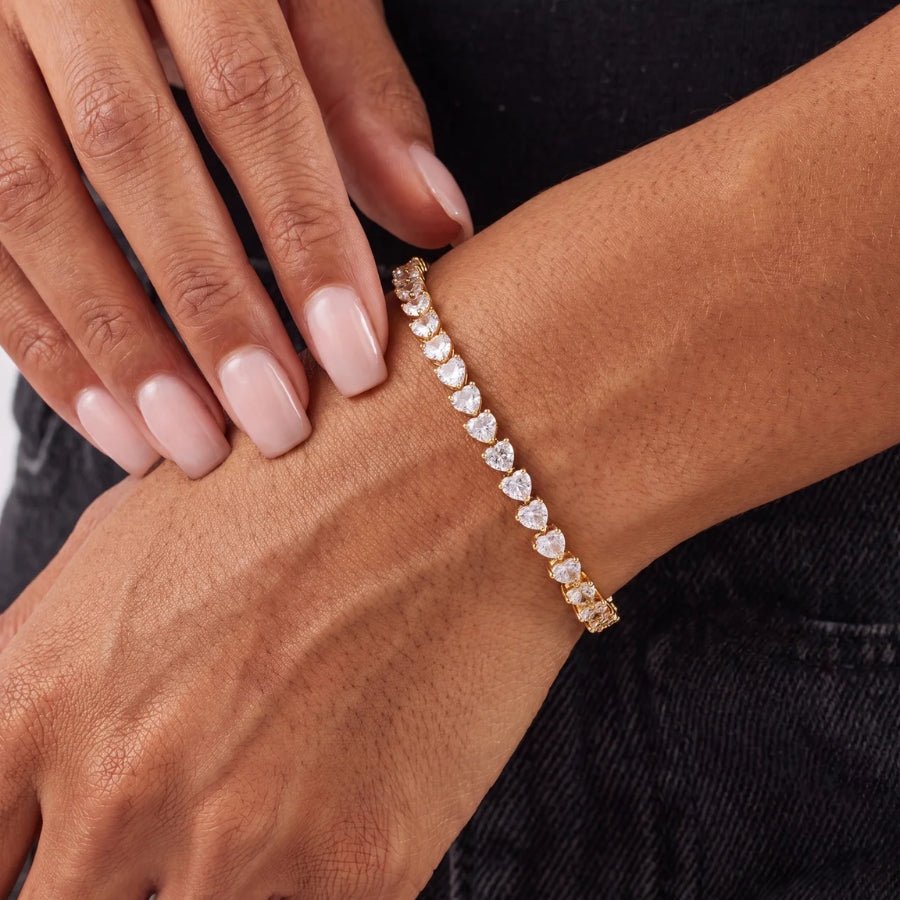 Heart cut gold tennis bracelet